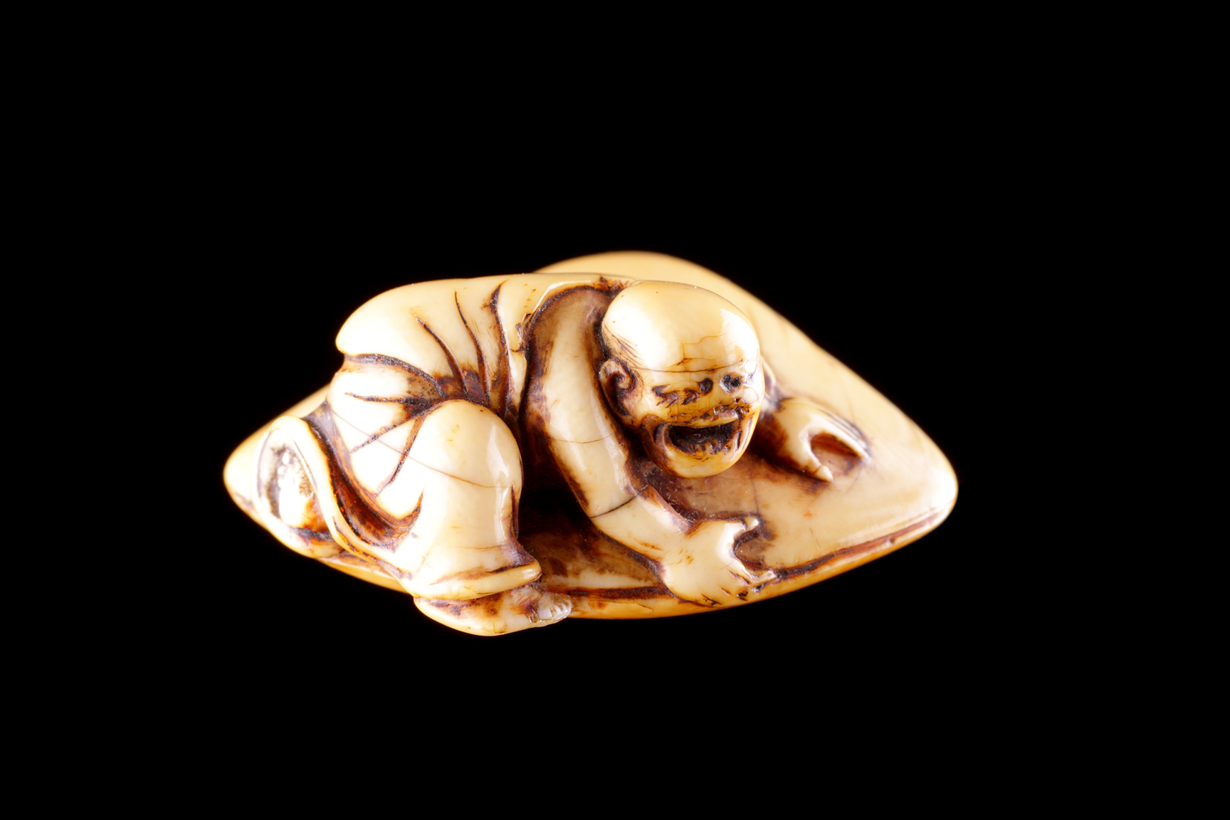 Japanese Carved Ivory Netsuke Depicting a Monk Dressed in His Flowing Robes his Hand Trapped in an Huge Clam 